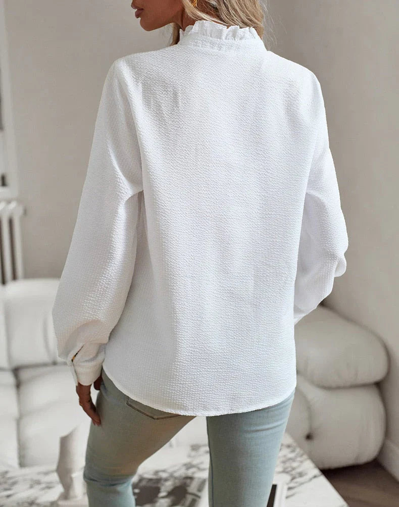 Designet elegant langermet bluse